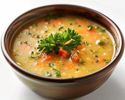 a bowl of soup with carrots and parsley photo