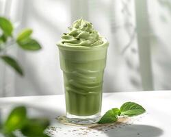 a green smoothie with whipped cream and mint leaves photo