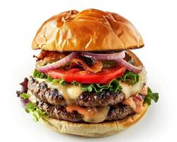 A large hamburger with cheese, bacon, and tomatoes photo