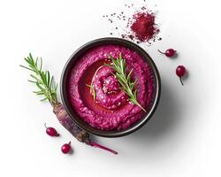 beetroot hummus with rosemary and spices in a bowl on a white background top view photo