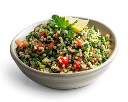 a bowl of couscous salad with a lemon wedge photo