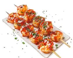 shrimp skewers with sauce and herbs on a white plate photo