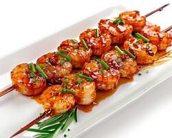 a plate of shrimp skewers with sauce and herbs photo