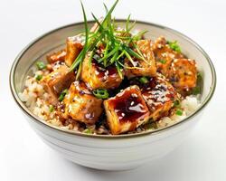 a bowl of rice and tofu with green onions photo