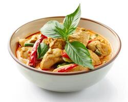 thai chicken curry in bowl with basil photo