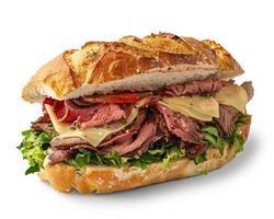 a sandwich with meat and vegetables on a white surface photo