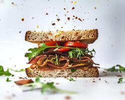 a sandwich with bacon, lettuce and tomato photo