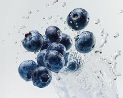 blueberries are being splashed into the water photo