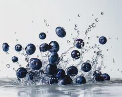 blueberries are splashing into the water photo