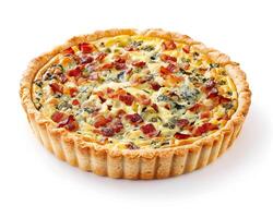 a quiche with bacon and spinach on a white background photo
