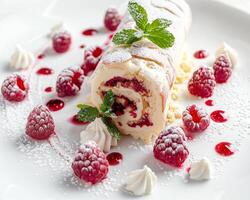 a dessert with raspberries and cream on a white plate photo