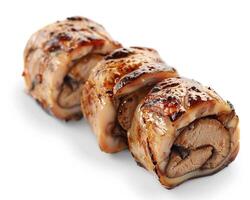 three pieces of meat wrapped in bacon on a white background photo