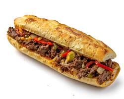 a sandwich with meat and peppers on a white surface photo