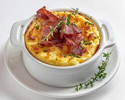 a white plate topped with a dish of food photo