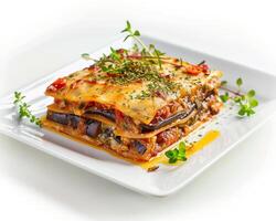 a plate of lasagna with vegetables and herbs photo