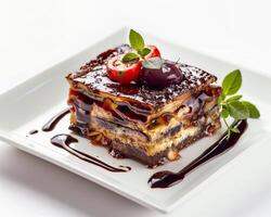 a piece of cake with chocolate sauce and cherry on top photo