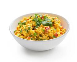 a bowl of scrambled eggs with cilantro on a white background photo