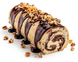 a roll of chocolate cake with nuts and chocolate drizzle photo