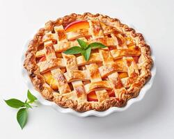 a pie with a lattice top and fresh green leaves photo