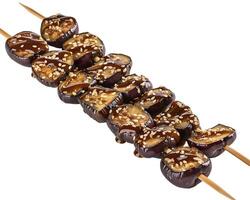 a skewered piece of fruit with a sauce on top photo