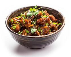 a bowl of food with some sauce and some herbs photo