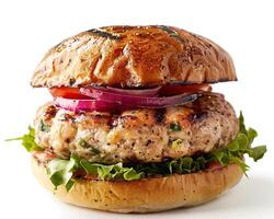 a hamburger with vegetables and meat on a bun photo