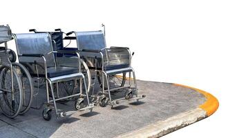 Isolated with clipping paths wheel chairs on dark gray footpath photo
