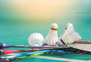 Badminton shuttlecocks on badminton rackets in badminton court soft and selective focus photo