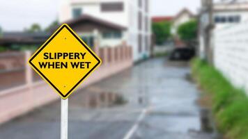 The text slippery when wet on yellow sign to show parking area will wet when raining photo