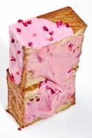 Cut in half fluffy cube shaped croissant with berry cream and candied raspberry crumble photo