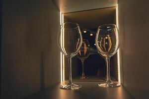Shelf with many empty glasses in evening light photo