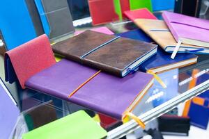 Multi-colored notepads on a counter in a supermarket. photo