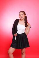 mature indonesia woman office model standing elegantly wearing black formal half coat hands holding shoulders, for corporate, fashion, commercial, agency content photo