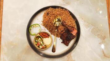 portrait flat lay nasi kebuli kebuli rice in the middle, typical Arabic food made in Indonesia on the table with empty space on the right and left sides photo