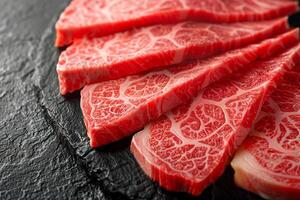 Raw Marbled Beef Slices on Black Plate. photo