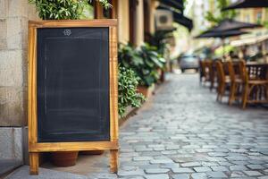 Empty Chalkboard Sign Outside Cafe with . photo