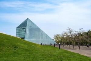SAPPORO, JAPAN - 05 MAY 2024 . The symbol of Moerenuma park, the glass pyramid Hidamari, on February 5 in Sapporo. The glass pyramid is multi-purpose space, such as cultural activities and museum photo