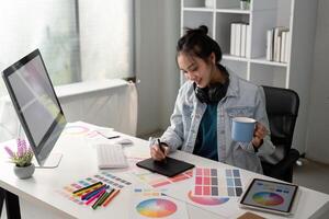 UX designer. Work on creative applications. Man with a palette in his hands. Designer applies the primary colors to the monitors. Development of a training application. Designer is a freelancer photo