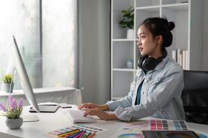 UX designer. Work on creative applications. Man with a palette in his hands. Designer applies the primary colors to the monitors. Development of a training application. Designer is a freelancer photo