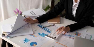 Documents, Business woman and accountant reading report for information, financial data or analysis. Paperwork, auditor check, review and bookkeeping, Calculate finance and tax in office photo