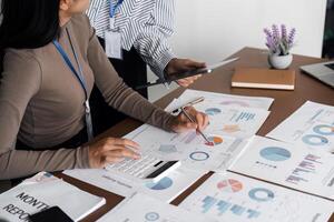 Business professional analyzing data and report with digital tablet and calculator. Concept of teamwork and financial analysis photo