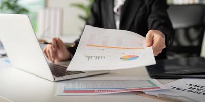 Documents, Business woman and accountant reading report for information, financial data or analysis. Paperwork, auditor check, review and bookkeeping, Calculate finance and tax in office photo