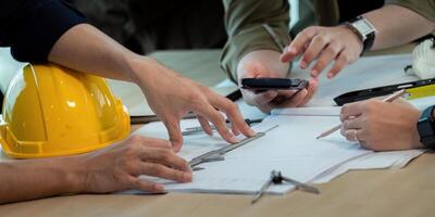 Construction and structure of engineer or architect meeting for project working with partner and tools on model building and blueprint in working site photo