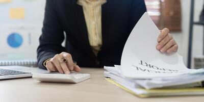 Accountant, bookkeeper using calculator to calculate financial report . account and allocating company budget. photo