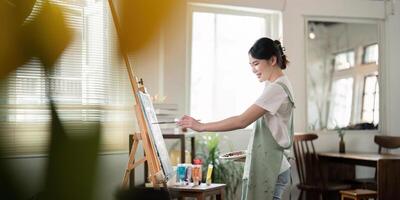 Talented Artist Painting in Bright Workshop Studio with Natural Light and Creative Atmosphere, Capturing the Essence of Artistic Expression and Inspiration in a Modern Workspace photo