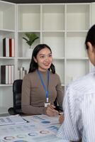 Two Business Professionals Engaged in Planning and Analysis Discussion in Modern Office Setting photo