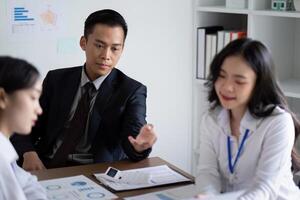 Business Team Discussing Analysis and Planning in a Modern Office Setting During a Meeting photo