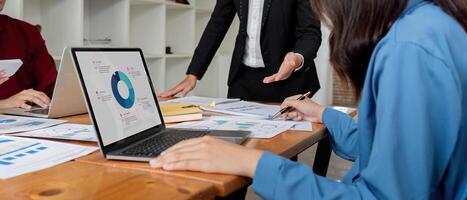 Business Team Discussing Financial Analysis with Charts and Graphs in Modern Office Setting for Strategic Planning and Decision Making photo