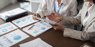 Business Teamwork Planning and Analysis Discussion with Charts and Graphs in a Modern Office Setting photo