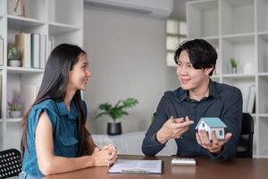 Real Estate Agent Discussing Property Sale Contract with Client in Modern Office Setting photo